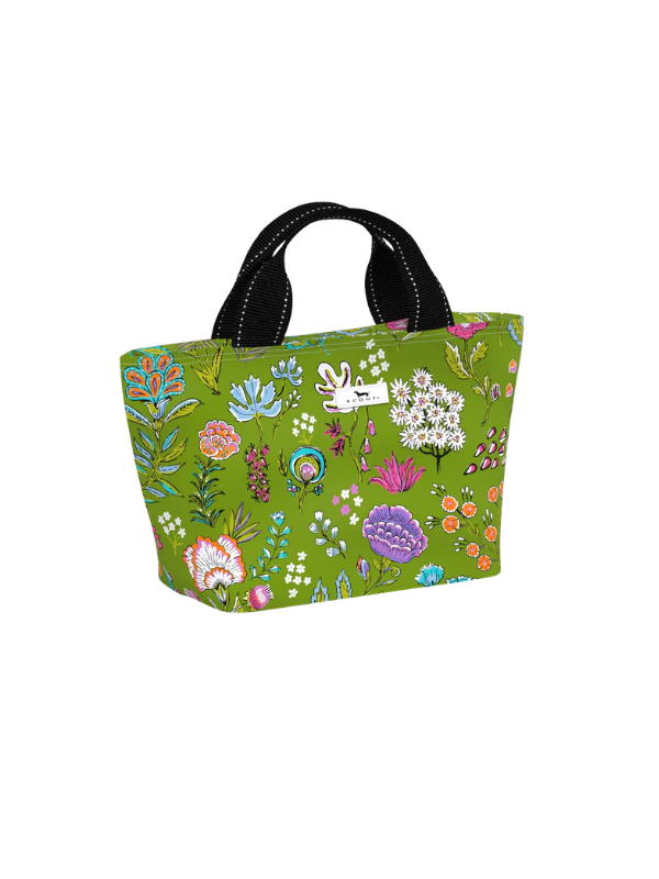 A green canvas tote bag with a colorful wildflower and bunny pattern, featuring black shoulder straps with white stitching