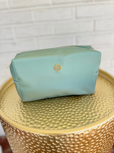 Green cosmetic bag lined with floral print and zipper