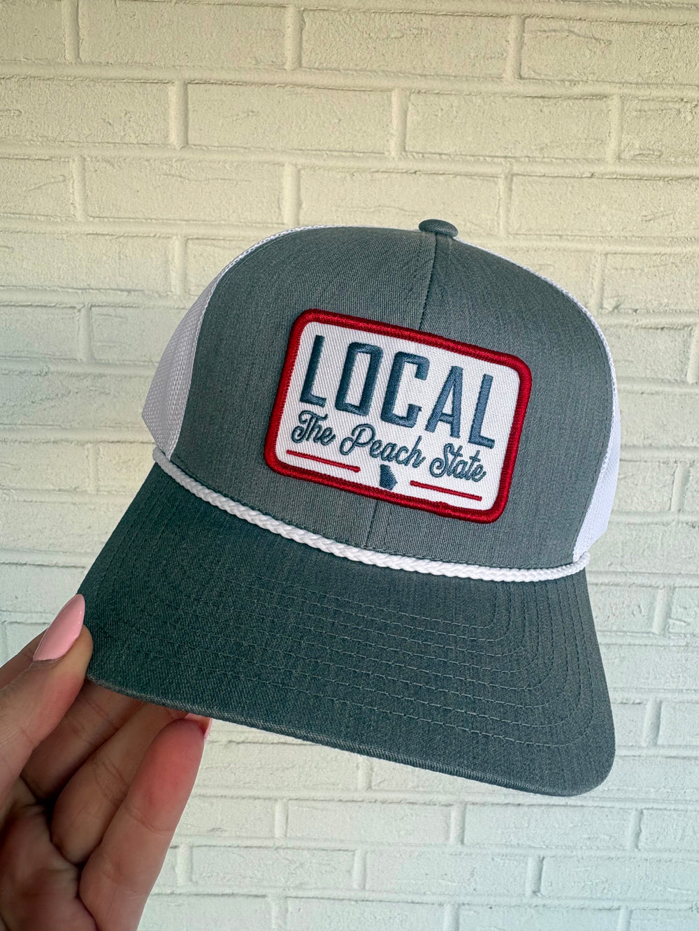 Grey and white mesh back rope trucker hat with patch local the peach state georgia pride 