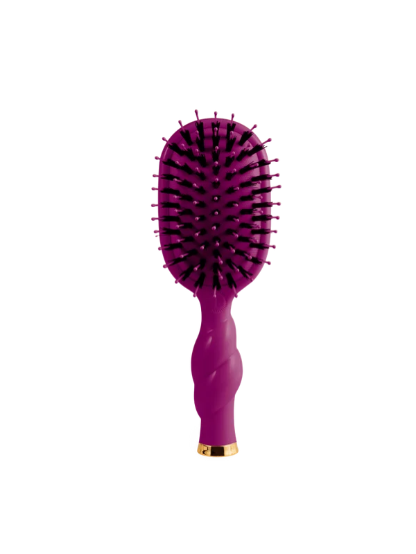 A purple oval hairbrush with black bristles and a gold accent at the base
