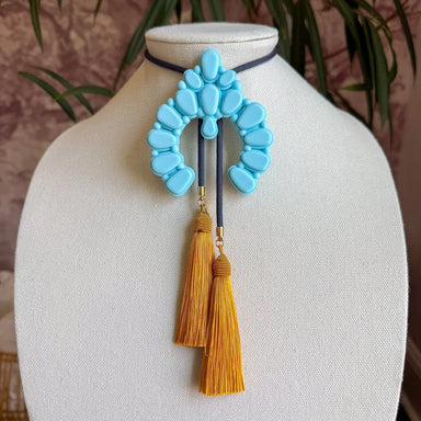 A bold reimagining of an iconic western silhouette, the Naja Bolo Necklace brings oversized charm and unmistakable personality to any look.