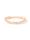 A delicate gold wire bracelet featuring a series of small, teardrop-shaped pale pink pearls, displayed on a clean white background.