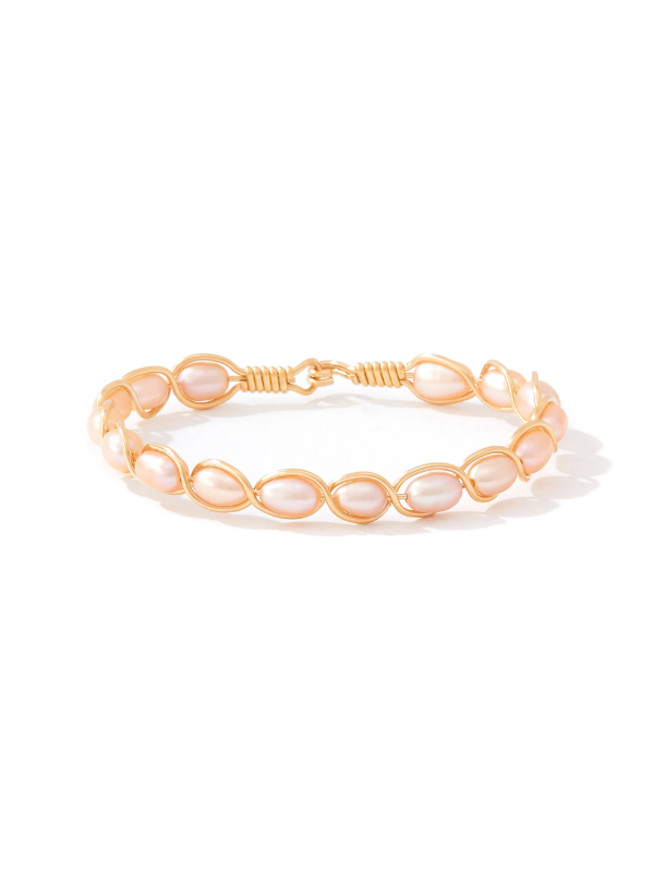A delicate gold wire bracelet featuring a series of small, teardrop-shaped pale pink pearls, displayed on a clean white background.