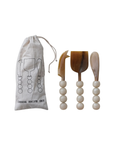 A cheese knife set with three wooden tools featuring white beaded handles, shown next to a beige drawstring pouch printed with 'CHEESE KNIFE SET'.
