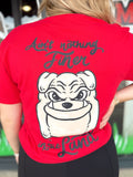 Red t-shirt with a bulldog graphic and text on the back, worn by a person.