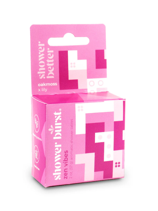Pink packaging of 'shower better' and 'zen vibes' shower tablets on a white background