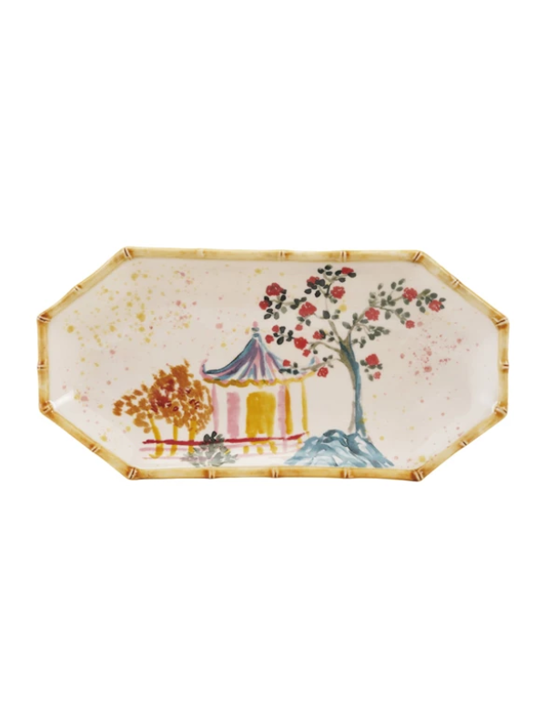 Decorative plate with a scenic design featuring a pagoda and trees on a white background