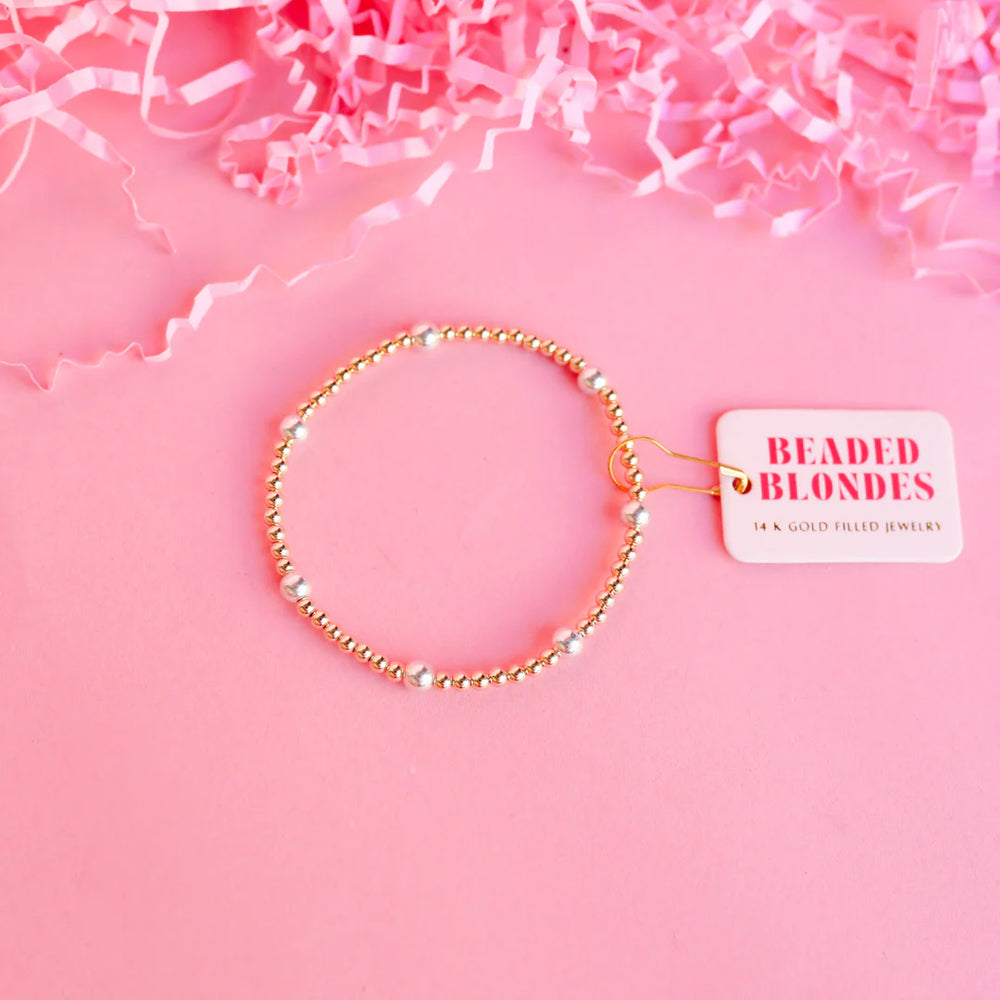 A gold-filled beaded bracelet with silver accents.