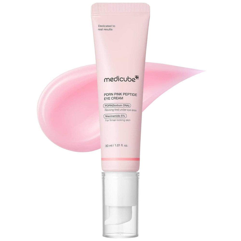 Pink eye cream tube with pink smear on a white background