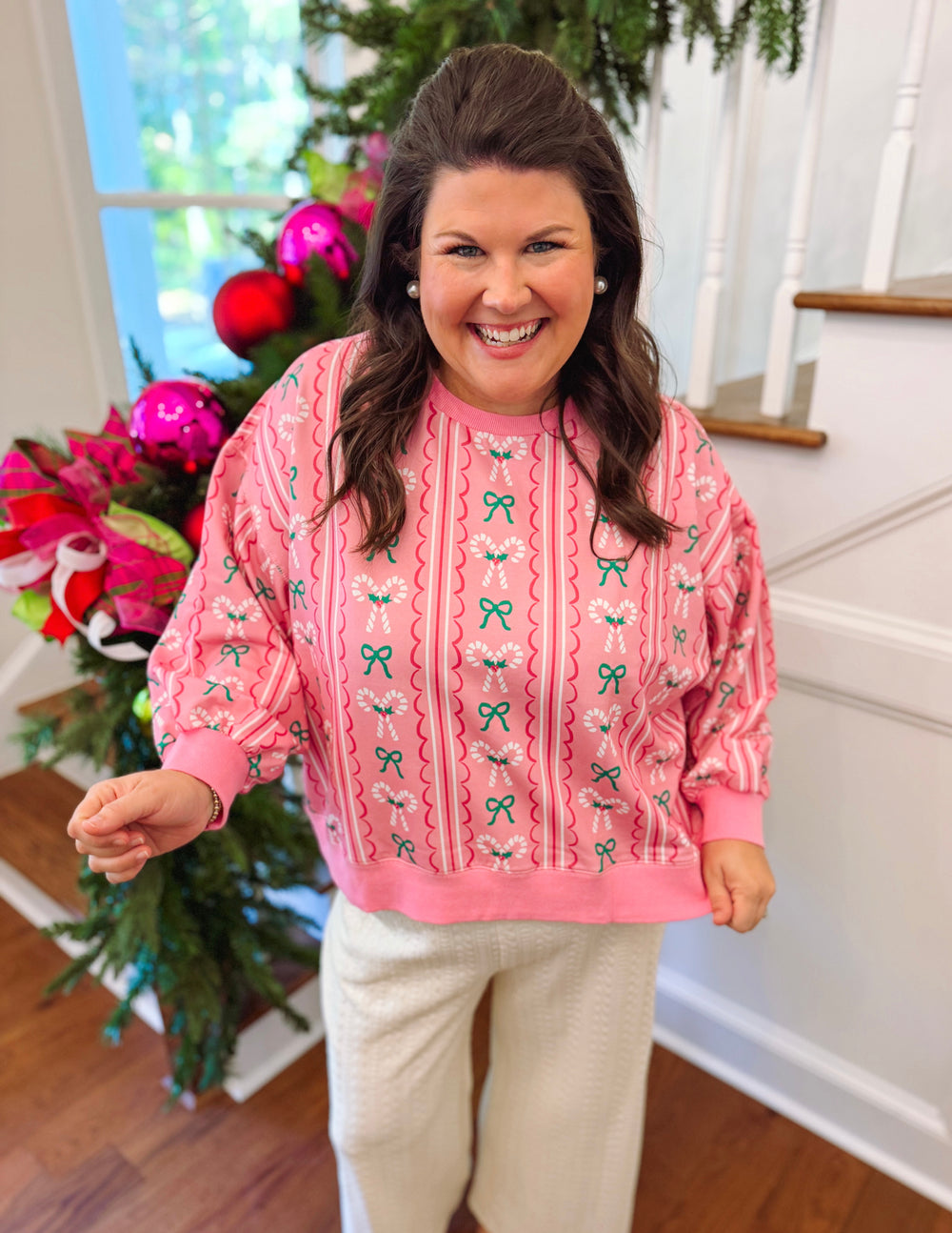 pink sweatshirt with candy canes and green bows
