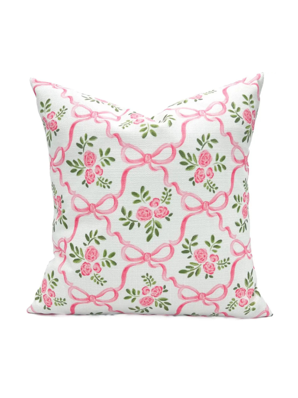 Decorative pillow with pink bows and flowers