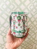  insulated tumbler with a holiday nutcracker and wreath pattern, featuring the text 'swig' and 'ROSANNEBECK collections' on the front, set against a green and white geometric patterned background.