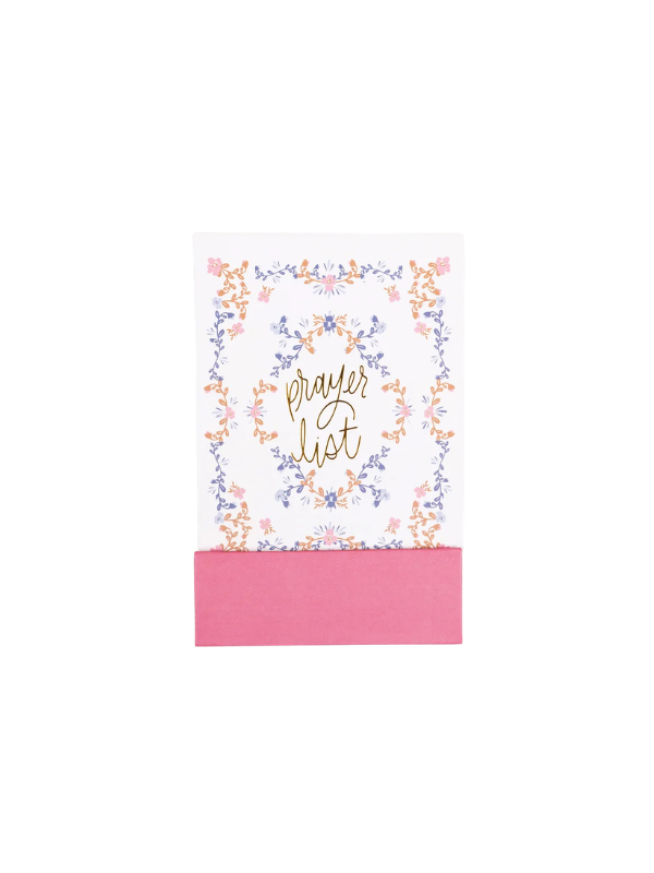A small white card or notebook with a pink paper band at the bottom, decorated with a delicate floral border in pastel pink, blue, and orange around the words 'prayer list' in gold script.