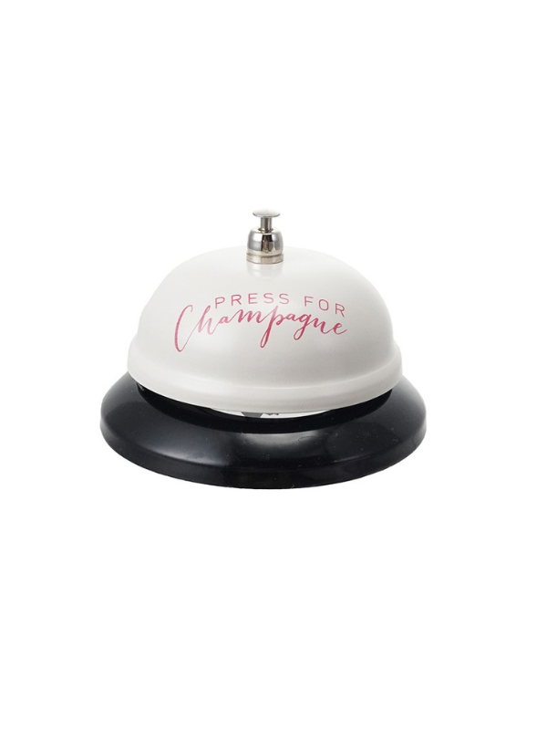 white desk bell with pink writing 