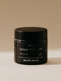 Black jar of beard balm on a beige background