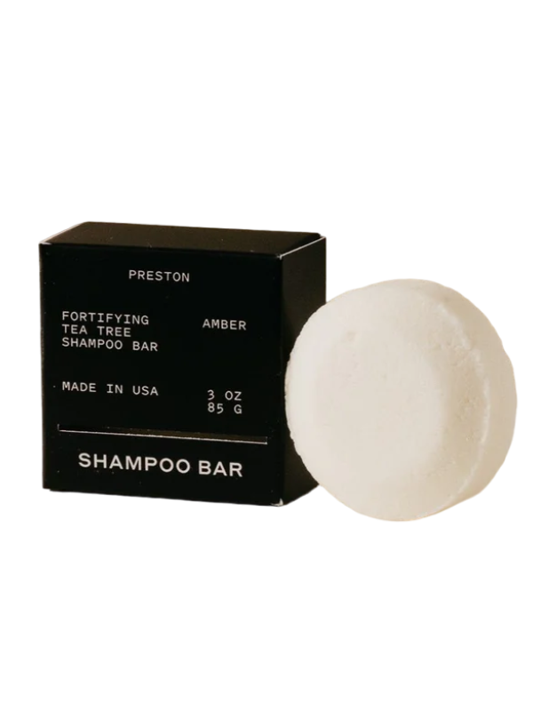 Shampoo bar and black box with 'Preston' branding on a white background