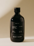 Black body wash bottle with label on a beige background