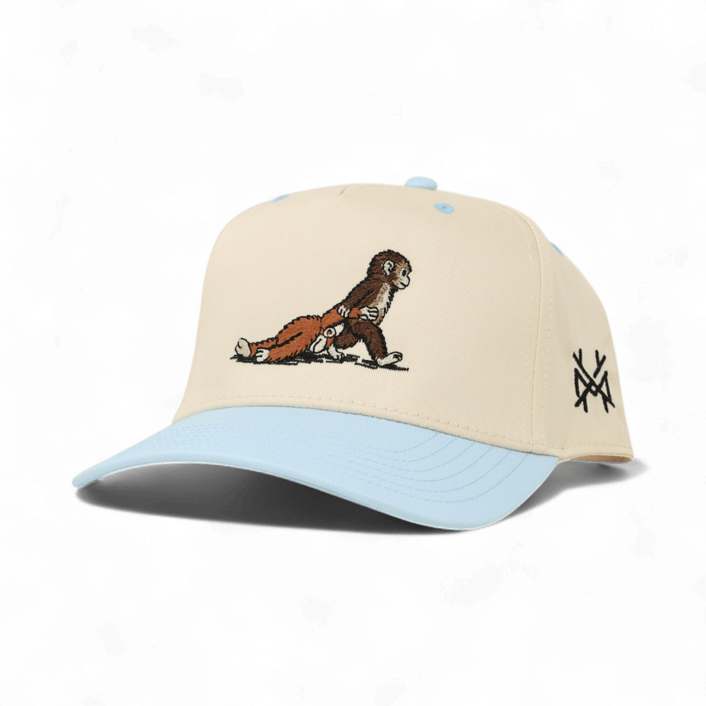 monkey dragging a toy monkey blue trucker hat 