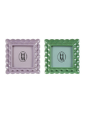 Two decorative square picture frames with scalloped edges, one in light purple and one in green