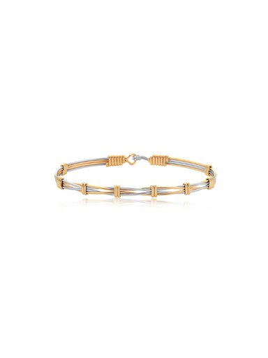 Two-tone gold and silver bracelet on a white background