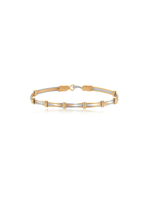 Two-tone gold and silver bracelet on a white background