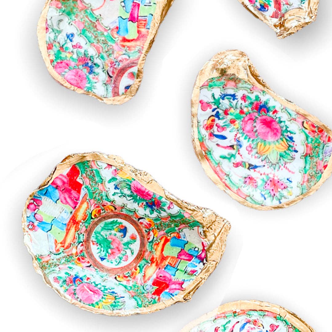 Colorful floral designs on decorative shell plates on a white background