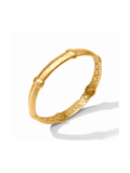A gold hinged bangle bracelet with a textured, bamboo-inspired design and geometric patterns on the inner band