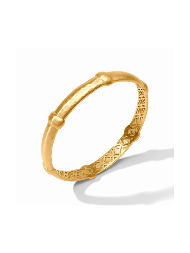 A gold hinged bangle bracelet with a textured, bamboo-inspired design and geometric patterns on the inner band