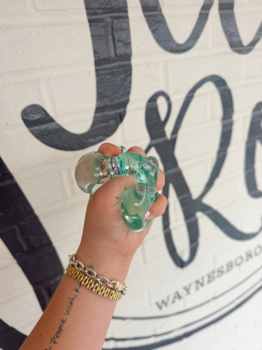 Clear sea life squishy toy filled with glitter and miniature ocean creatures inside for sensory play and stress relief.