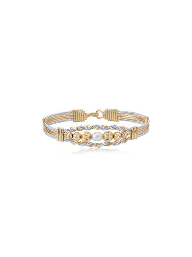 Gold and silver bracelet with pearls on a white background