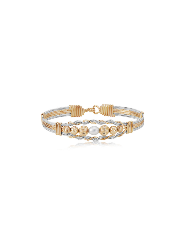 Gold and silver bracelet with pearls on a white background