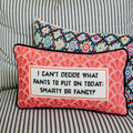 Decorative pillow with text on a striped couch