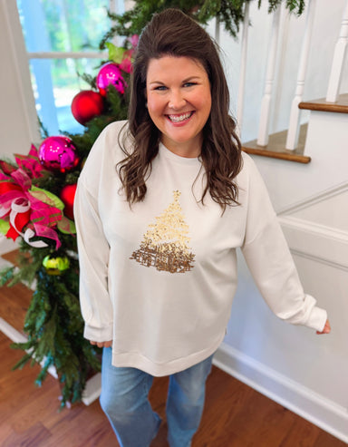 white sweatshirt with a gold sequin tree on the front 