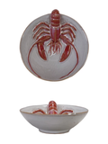 Ceramic dish with a red lobster design on a white background