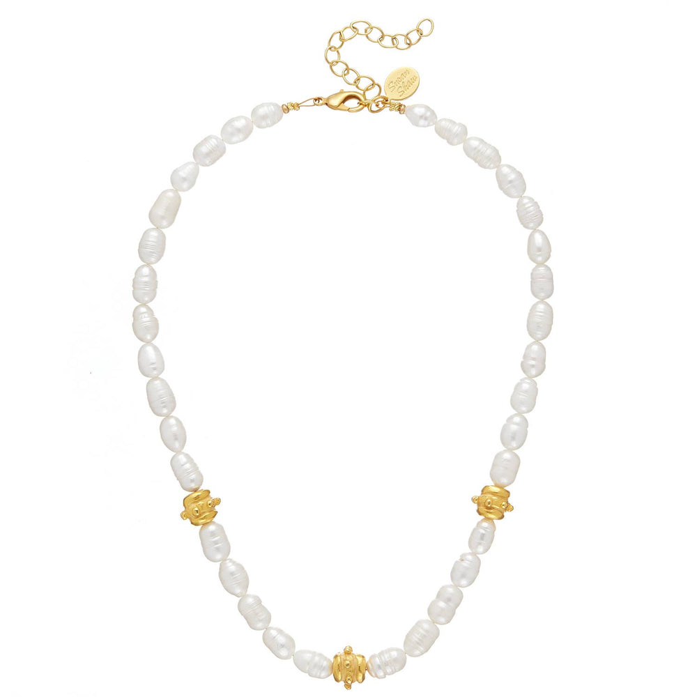 Pearl necklace with gold accents on a white background