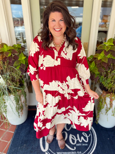 This maxi dress features an allover floral print with a tiered silhouette that gives it beautiful movement. 