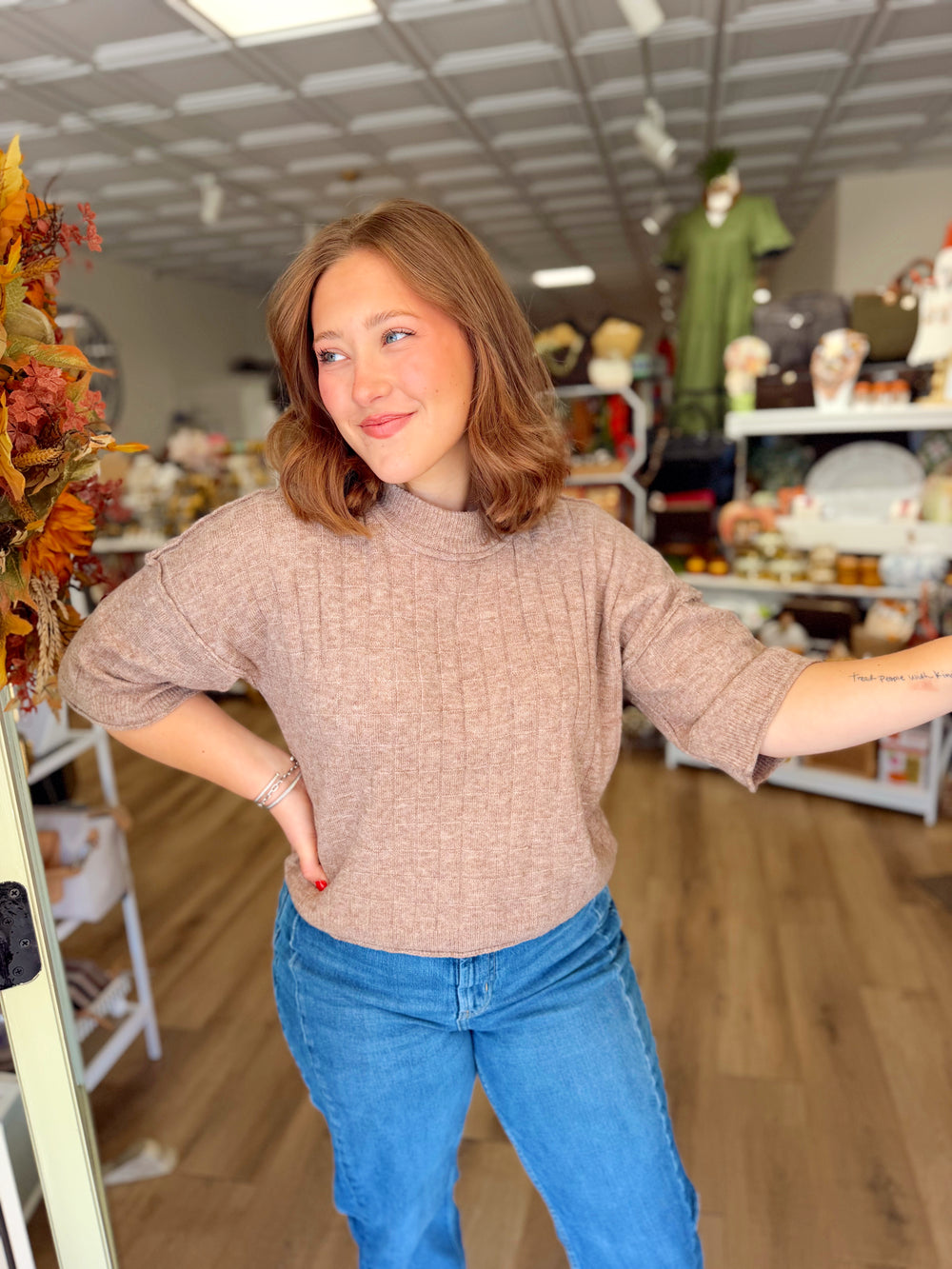  This mocha sweater features a subtle textured knit design, relaxed mock neckline, and roomy three-quarter sleeves for an effortlessly comfortable fit. 