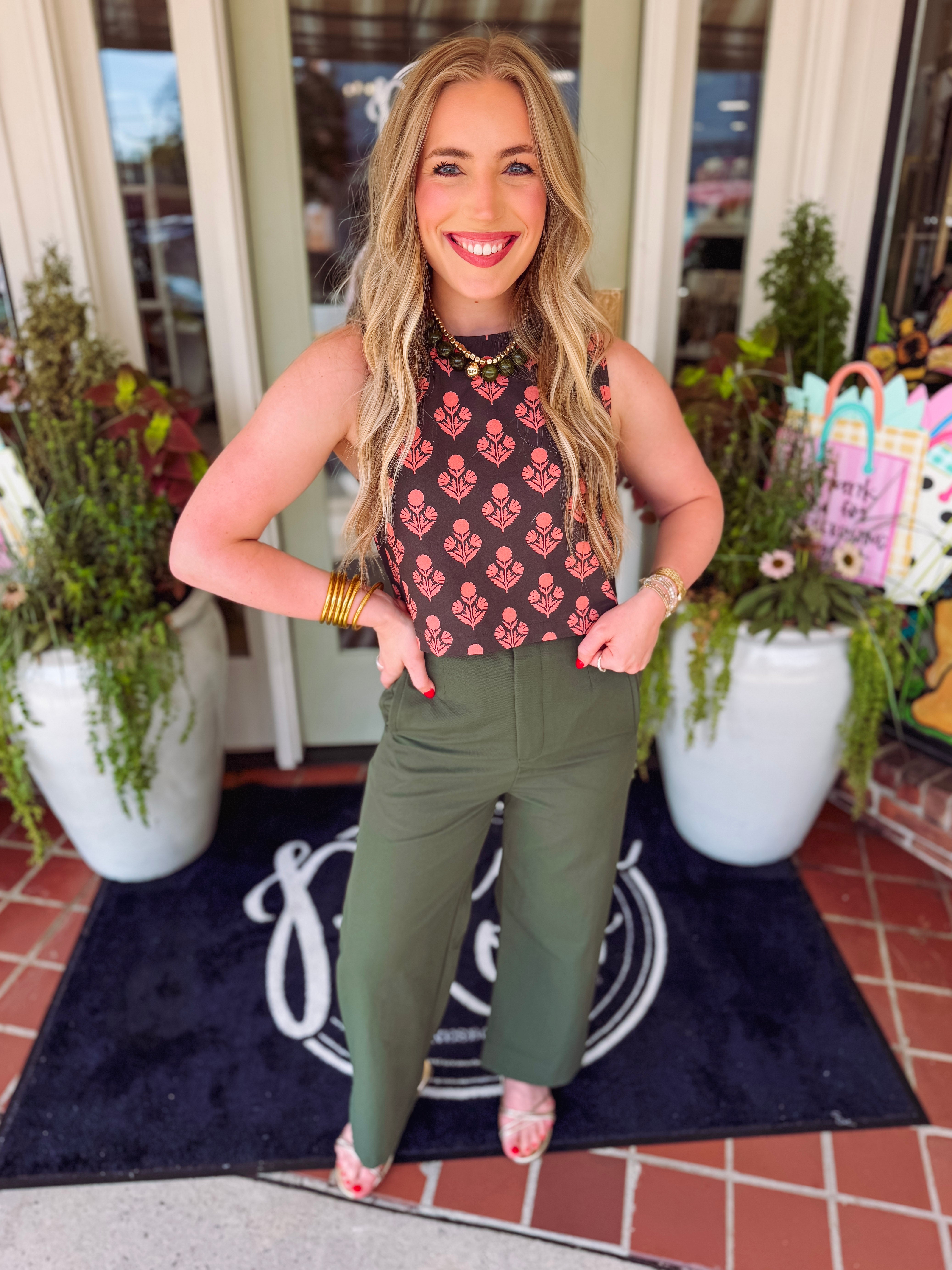 Brown base floral cropped length top with buttons down the back 