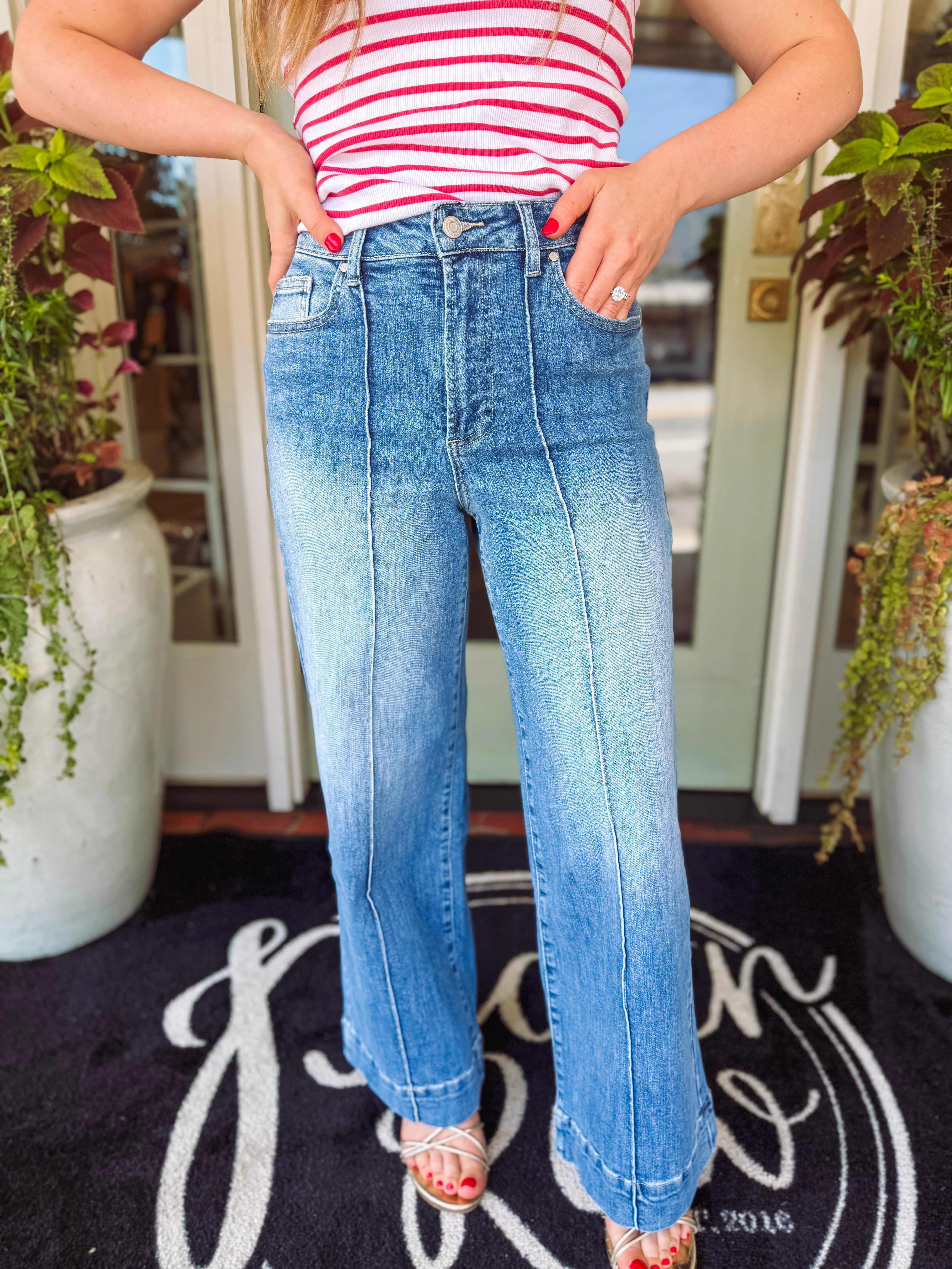 Medium wash high rise pin tuck detail wide leg jeans