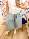  These pants feature a soft blue and ivory gingham print with a relaxed, extra-wide silhouette and pleated detailing through the front. 