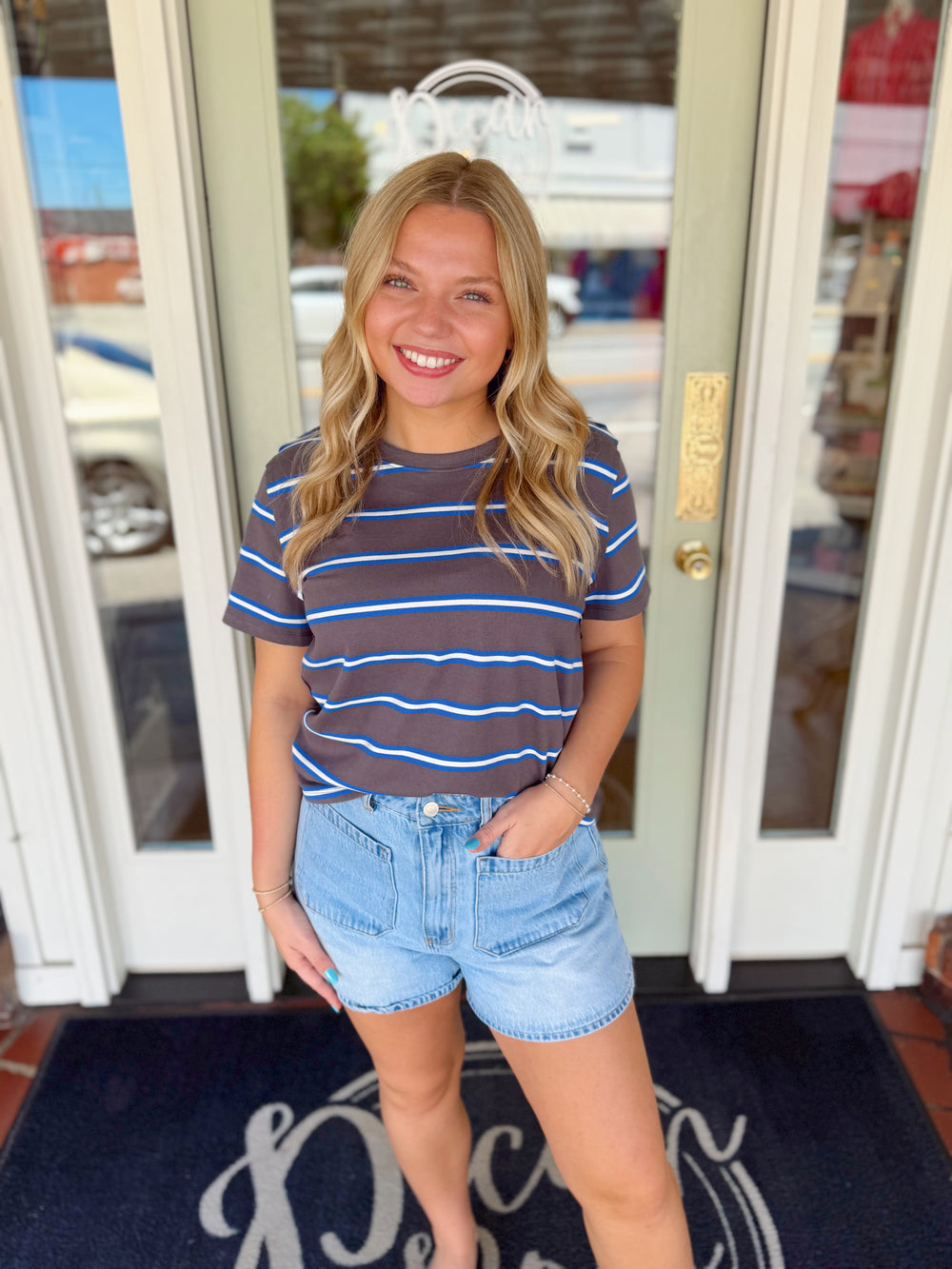 Charcoal short sleeve striped tee with blue and white horizontal stripes and relaxed casual fit.
