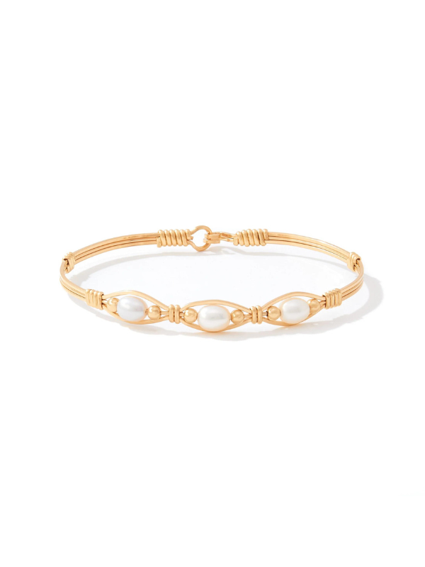 Gold bracelet with pearls on a white background