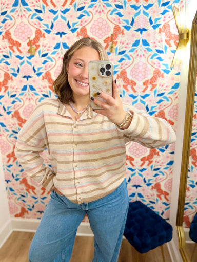 This cardigan features a creamy neutral base with muted pink, blue, and taupe stripes for an easy pop of color without feeling too bright. 