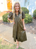 This dress features a rich olive hue with a subtle textured jacquard pattern that gives it an elevated finish.