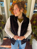 black lined fur vest with one hook to close it 