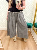 These black and cream gingham pants feature a relaxed wide-leg silhouette with pretty pleated detailing for a little extra shape and movement. 