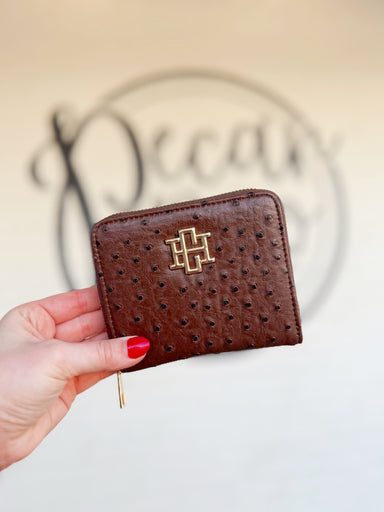 A sleek brown textured zip wallet with a gold CH emblem on the front 