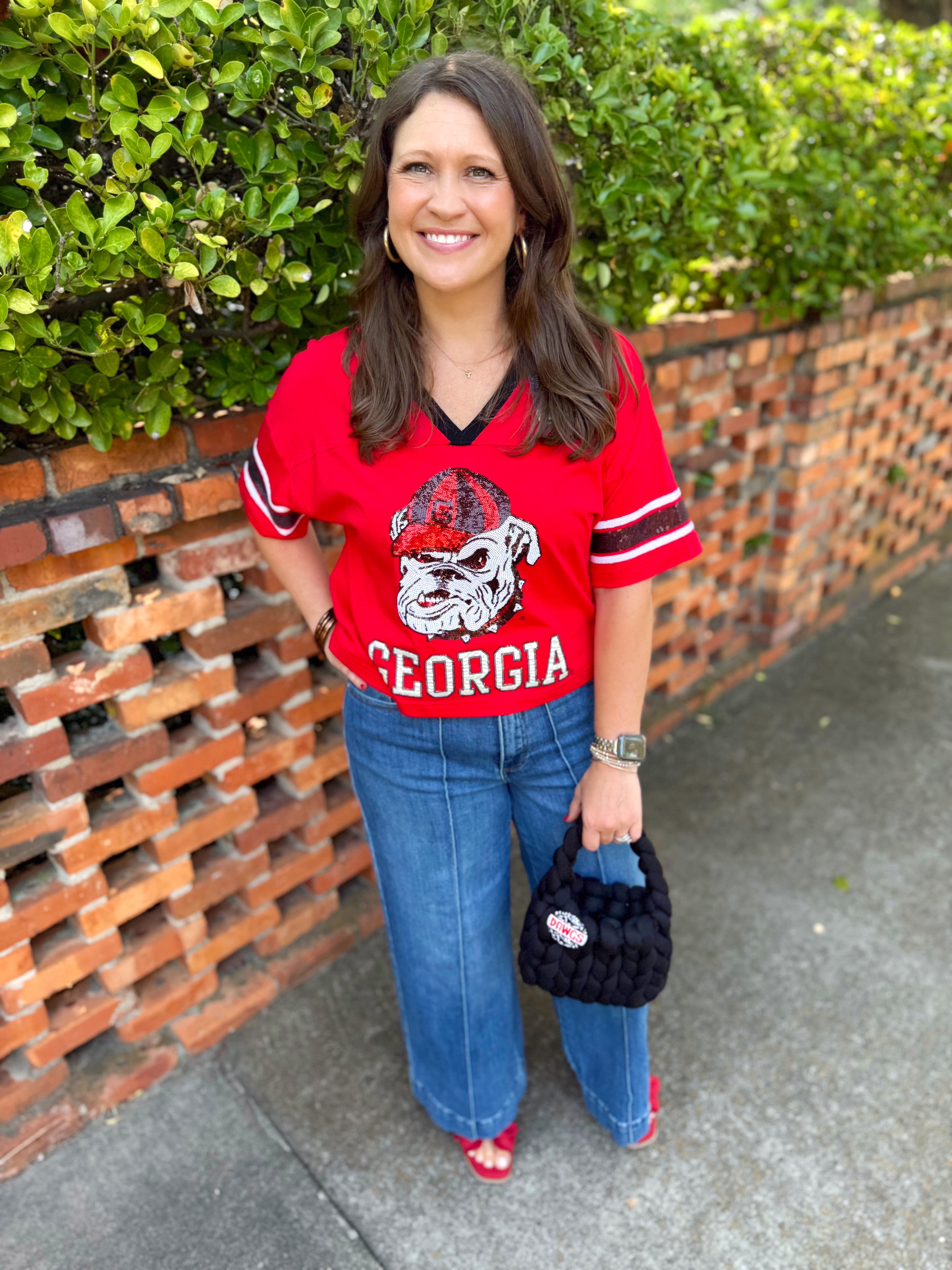 A sparkly short-sleeve Georgia football jersey tee with a large bulldog graphic and 'GEORGIA' text.