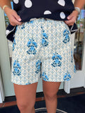 Blue and ivory tailored shorts featuring a floral toile-inspired print with delicate lattice detailing and a polished structured silhouette.