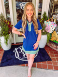 Navy Mary Square dress with green trim and a v-neckline 